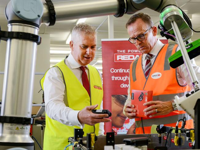 REDARC CEO Anthony Kittel, left, and Advanced Manufacturing Growth Centre (AMGC) Managing Director, Dr Jens Goennemann inspect a collaborative robot at the REDARC Lonsdale facility,  Thursday, February 18, 2021. Picture: Brenton Edwards