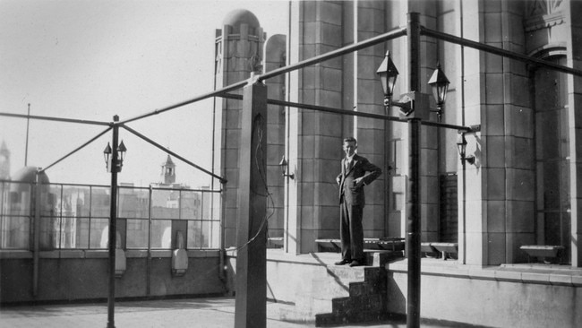 A man stands on the roof of Melbourne’s Manchester Unity Building shortly after its construction in 1932. Picture: State Library of Victoria