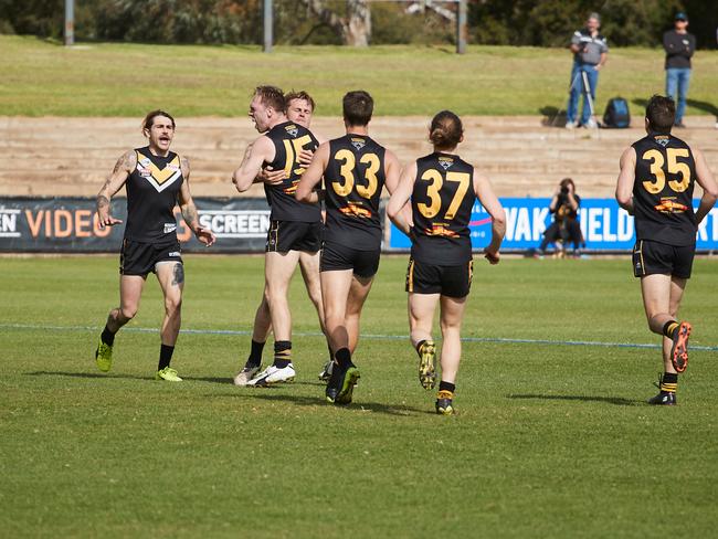 Brighton players celebrate a goal in last season’s division three grand final versus Golden Grove. Picture: AAP Image/Matt Loxton.