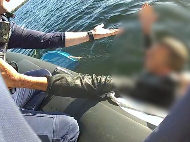 Police have released video of a daring rescue near a popular dolphin watching spot after a man was found clinging to a sunken boat.  Picture: Queensland Police