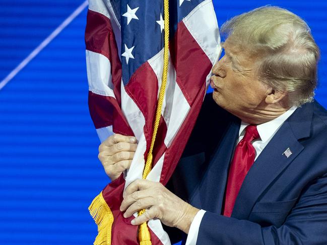 Republican presidential candidate former President Donald Trump kisses the flag as arrives to speak during the Conservative Political Action Conference, CPAC 2024, at National Harbor, in Oxon Hill, Md., Saturday, Feb. 24, 2024. (AP Photo/Alex Brandon)