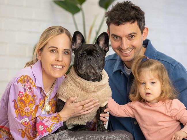 Sarah Gargiulo, Tom Gargiulo and two-year-old Eleanor with Picnic the French Bulldog Picnic who is paralysed. Picture: Jason Edwards