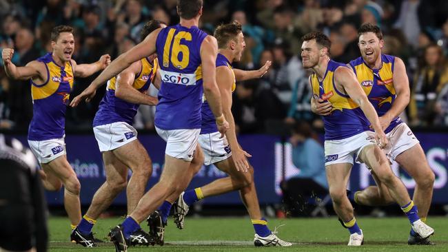 Luke Shuey is mobbed by teammates after his match-winning goal.