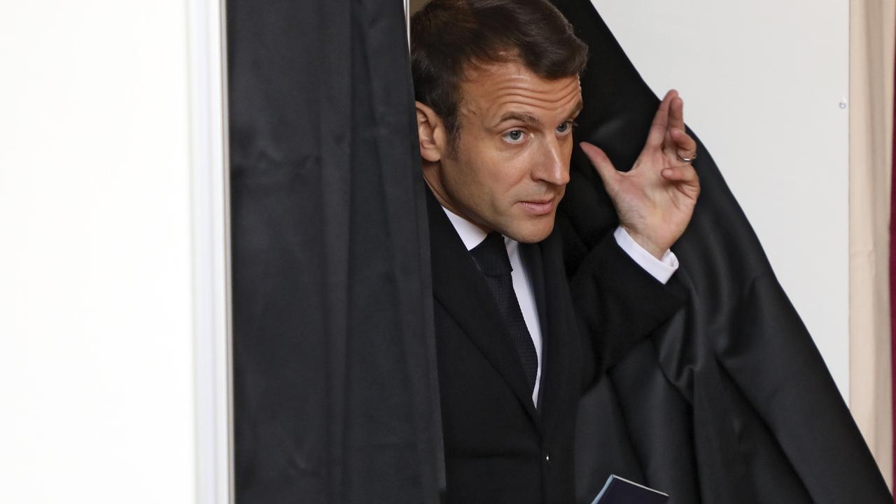 French President Emmanuel Macron exits a voting booth before voting for the European parliamentary elections in northern France. Picture: Ludovic Marin