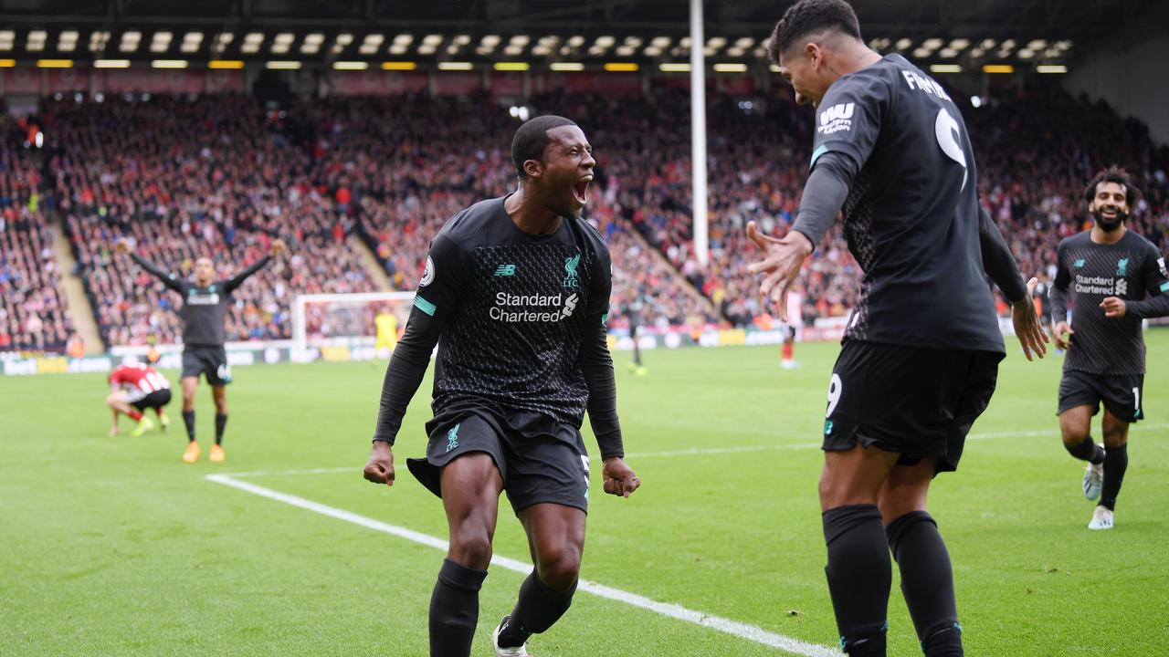 Georginio Wijnaldum celebrates with Roberto Firmino after scoring.