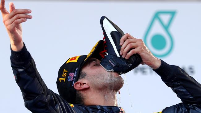 His signature gesture: Daniel Ricciardo celebrates his win at the 2016 Malaysia Formula 1 Grand Prix with a ‘shoey’.