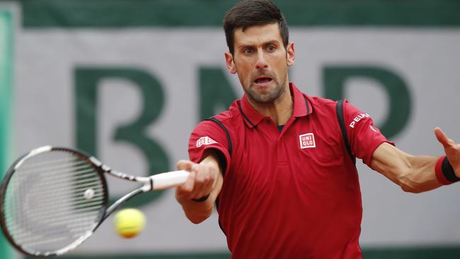 Novak Djokovic narrowly avoids hitting a linesman with his racquet.