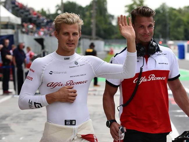 Ericsson (L) waves after a medical check-up following his spectacular crash. Picture: AFP