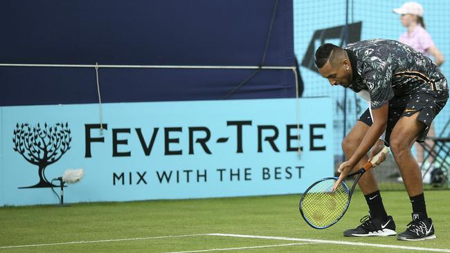 Nick Kyrgios shows the umpire where he thinks the ball landed.