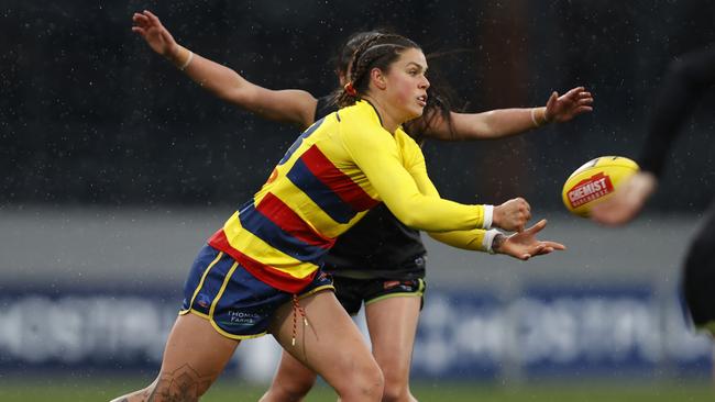 Anne Hatchard handballs as heavy rain falls at Ikon Park. Picture: Darrian Traynor/AFL Photos/via Getty Images