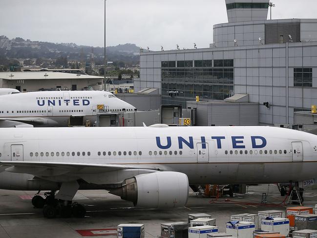 (FILES) This file photo taken on July 07, 2015 shows United Airlines planes on the tarmac at San Francisco International Airport in San Francisco, California.  United Airlines found itself in the middle of a social media storm on April 10, 2017, after the US carrier forcefully removed a passenger from a flight due to overbooking.  The incident occurred Sunday on a United Express flight bound for Louisville, Kentucky, from Chicago. United Express flights are operated by one of eight regional airlines which partner with United.   / AFP PHOTO / GETTY IMAGES NORTH AMERICA / JUSTIN SULLIVAN