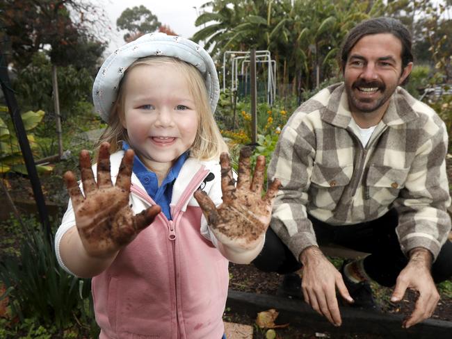 University of Adelaide PhD candidate Jacob Mills with Abi (3) in the Fern Ave Community Garden. Research showing revegetation can restore the natural diversity of soil microbes, with potential human health benefits. Photo Kelly Barnes