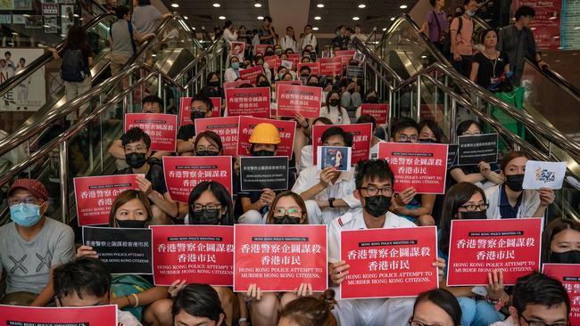 HONG KONG, CHINA - AUGUST 13: Members of the medical profession gather to protest against Hong Kong police brutality at Queen Elizabeth Hospital on August 13, 2019 in Hong Kong, China. Pro-democracy protesters have continued rallies on the streets of Hong Kong against a controversial extradition bill since 9 June as the city plunged into crisis after waves of demonstrations and several violent clashes. Hong Kong's Chief Executive Carrie Lam apologized for introducing the bill and declared it "dead", however protesters have continued to draw large crowds with demands for Lam's resignation and completely withdraw the bill. (Photo by Anthony Kwan/Getty Images)