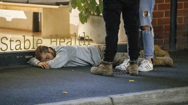 A man lies in the street in Prahran on Friday night. Picture: David Geraghty