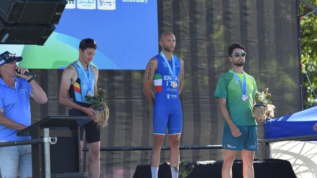 Elite Men's Cross Duathlon World Champion Michele Bonacina of Italy, with silver medallist Sebastien Carabin of Belgium and bronze medallist Benjamin Forbes of Australia.