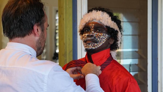 Laynhapuy Homelands School teacher Tom Hermes helping Matjirra Waṉambi with his tie ahead of his 2023 graduation ceremony.