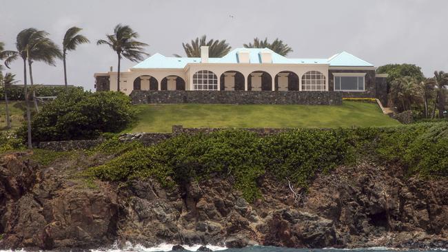 This Tuesday, July 9, 2019 photo shows a structure on Little Saint James Island, in the U. S. Virgin Islands. Locals recalled seeing Jeffery Epstein's black helicopter flying back and forth from the international airport in St. Thomas to his helipad on Little St. James Island, where he built a cream colored mansion with a bright turquoise roof surrounded by several other structures including the maids' quarters and a massive, square-shaped white building on one end of the island that some say is a music room fitted with acoustic walls. (AP Photo/Gianfranco Gaglione)