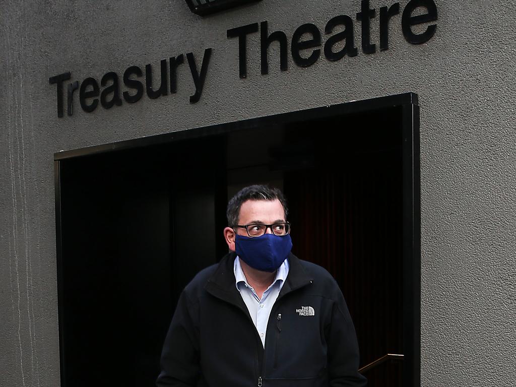 Premier Daniel Andrews walks from a press conference with a mask, just moments after making the protective gear mandatory. Ian Currie/ NCA NewsWire