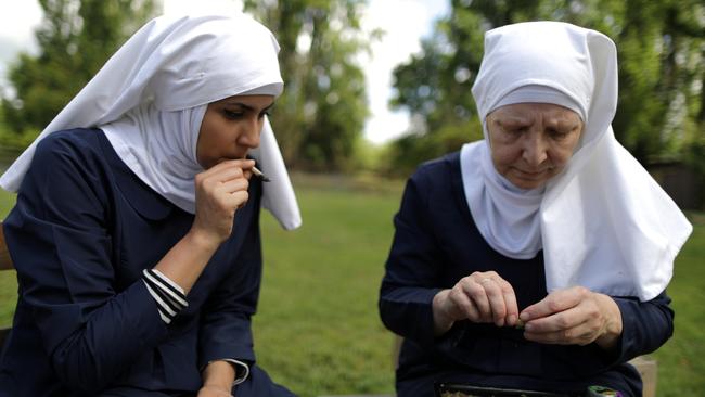 California "weed nun" Christine Meeusen, 57, (R), and India Delgado, who goes by the name Sister Eevee, smoke a joint at Sisters of the Valley near Merced, California, U.S., April 18, 2017. Picture taken April 18, 2017. REUTERS/Lucy Nicholson