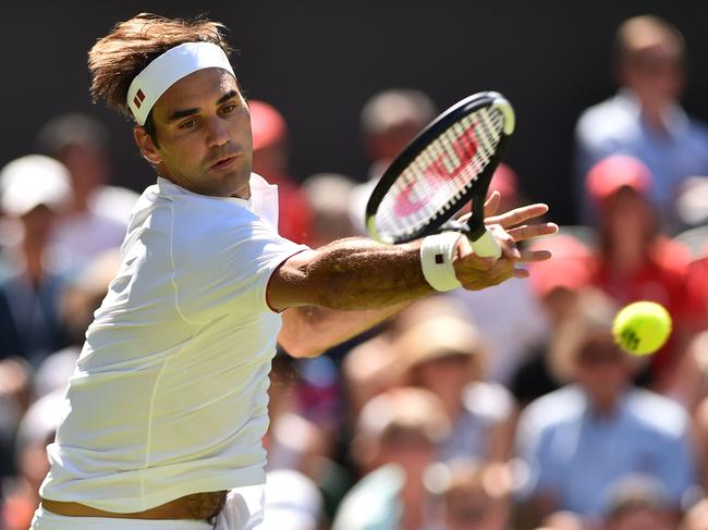 Switzerland's Roger Federer returns to Serbia's Dusan Lajovic during their men's singles first round match on the first day of the 2018 Wimbledon Championships at The All England Lawn Tennis Club in Wimbledon, southwest London, on July 2, 2018. / AFP PHOTO / Glyn KIRK / RESTRICTED TO EDITORIAL USE