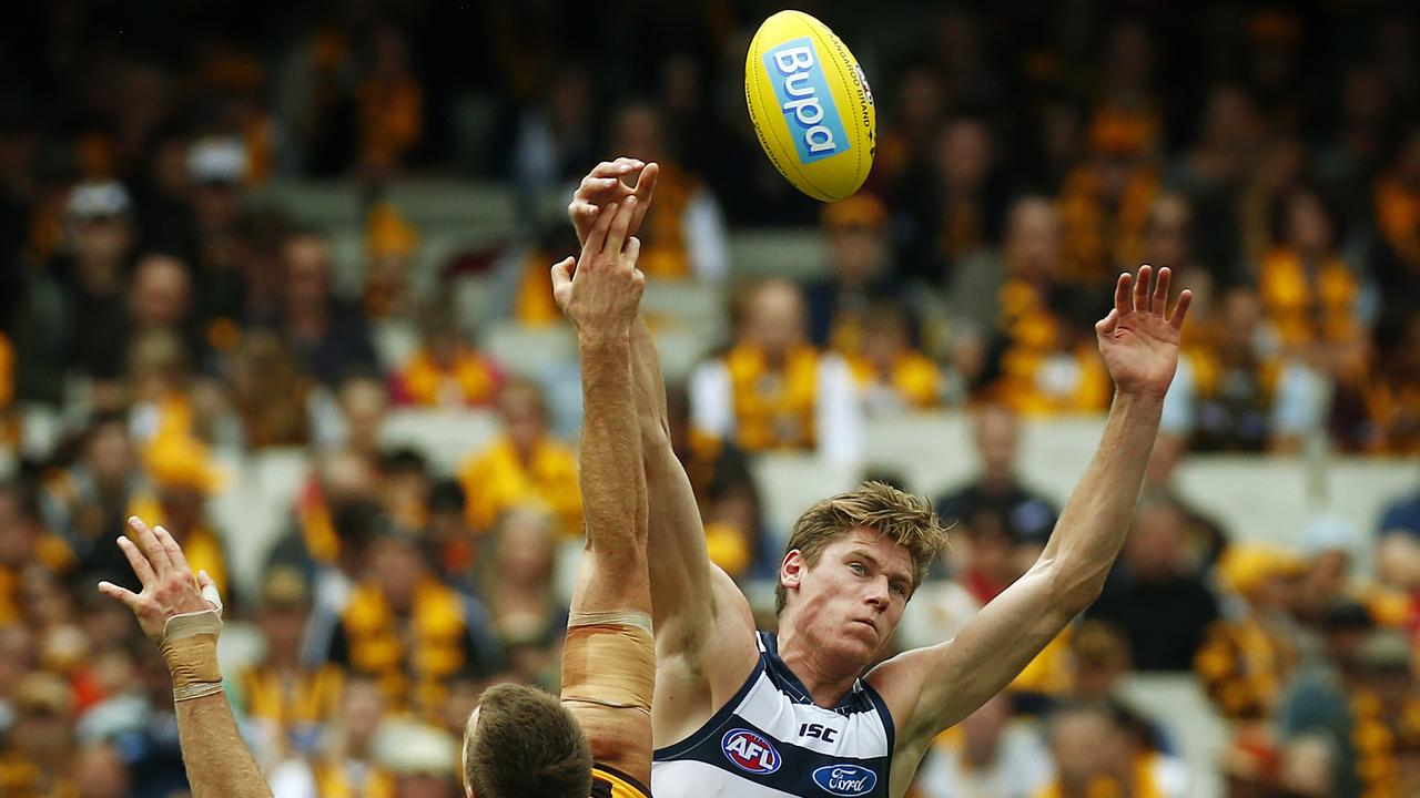 Mark Blicavs jumps over Max Bailey at the MCG on April 1, 2013.