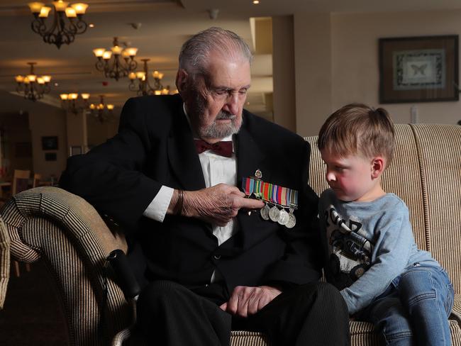 World War II veteran John Macdonald talks about his medals from his time in the Pacific to great grandson Connor Evans 4.  John was chatting about his experiences to mark the 75th anniversary of the end of World War II on August 15, 1945. John Lives at the Aveo The Domain Country Club. Picture Glenn Hampson