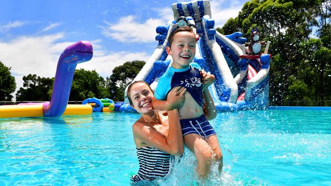 Megan Halliwell and her son Miles, 5, check out the world’s largest inflatable water park, Water Wonderland at Bonython Park. Picture: MARK BRAKE