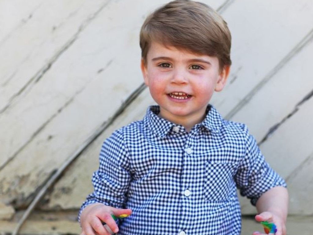 For Louis’ second birthday photo shoot, mum Kate let him loose with the rainbow paints. This cute shot was taken before he smeared the finger paint all over his face. Picture: Supplied