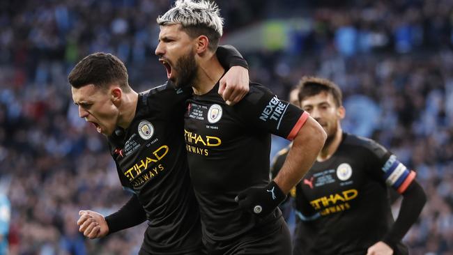 Manchester City’s Sergio Aguero, right, celebrates with his teammate Phil Foden after scoring his side’s first goal during the League Cup final against Aston Villa at Wembley Stadium in London. Picture: AP