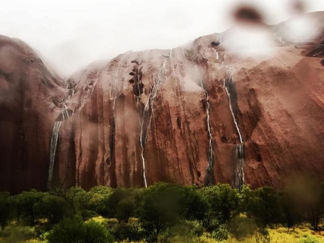 Waterfalls cascade down Uluru during December’s storms. Picture: Starfall214/Instagram