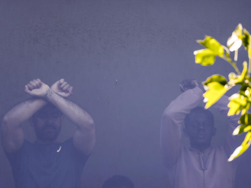 Refugees can be seen in a window of the Park Hotel in Carlton. Picture: NCA NewsWire / Ian Currie