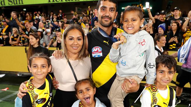 Marlion Pickett celebrates the premiership win with his family. Picture: AFL Photos/Getty Images