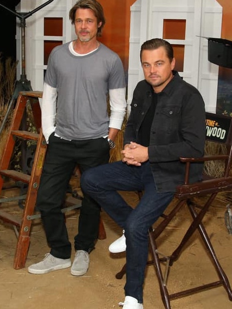 Leonardo DiCaprio wearing Outland denim jeans and jacket while promoting a film with Brad Pitt.