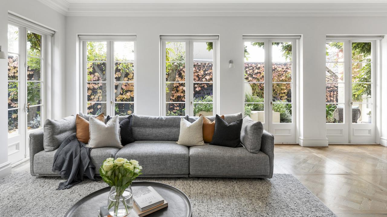 Inside the living room with large windows surrounding it.