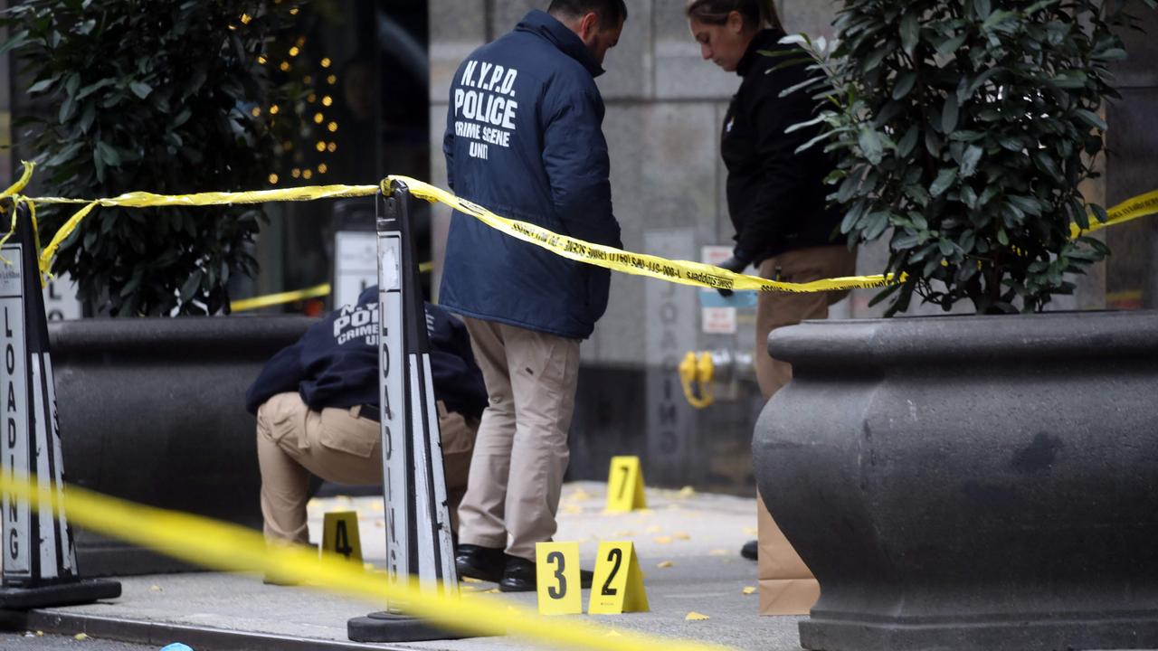 Police place bullet casing markers outside of a Hilton Hotel.