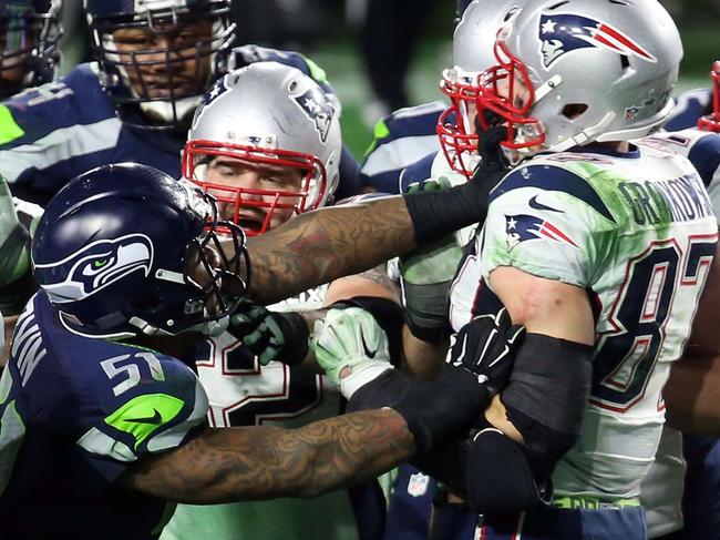 GLENDALE, AZ - FEBRUARY 01: Bruce Irvin #51 of the Seattle Seahawks and Rob Gronkowski #87 of the New England Patriots exchange words after a play late in the game during Super Bowl XLIX at University of Phoenix Stadium on February 1, 2015 in Glendale, Arizona. Andy Lyons/Getty Images/AFP == FOR NEWSPAPERS, INTERNET, TELCOS & TELEVISION USE ONLY ==