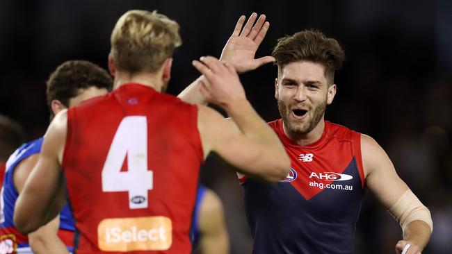 Melbourne's Tom Bugg high fives Jack Watts after the Dees kicked away early. Picture: Michael Klein