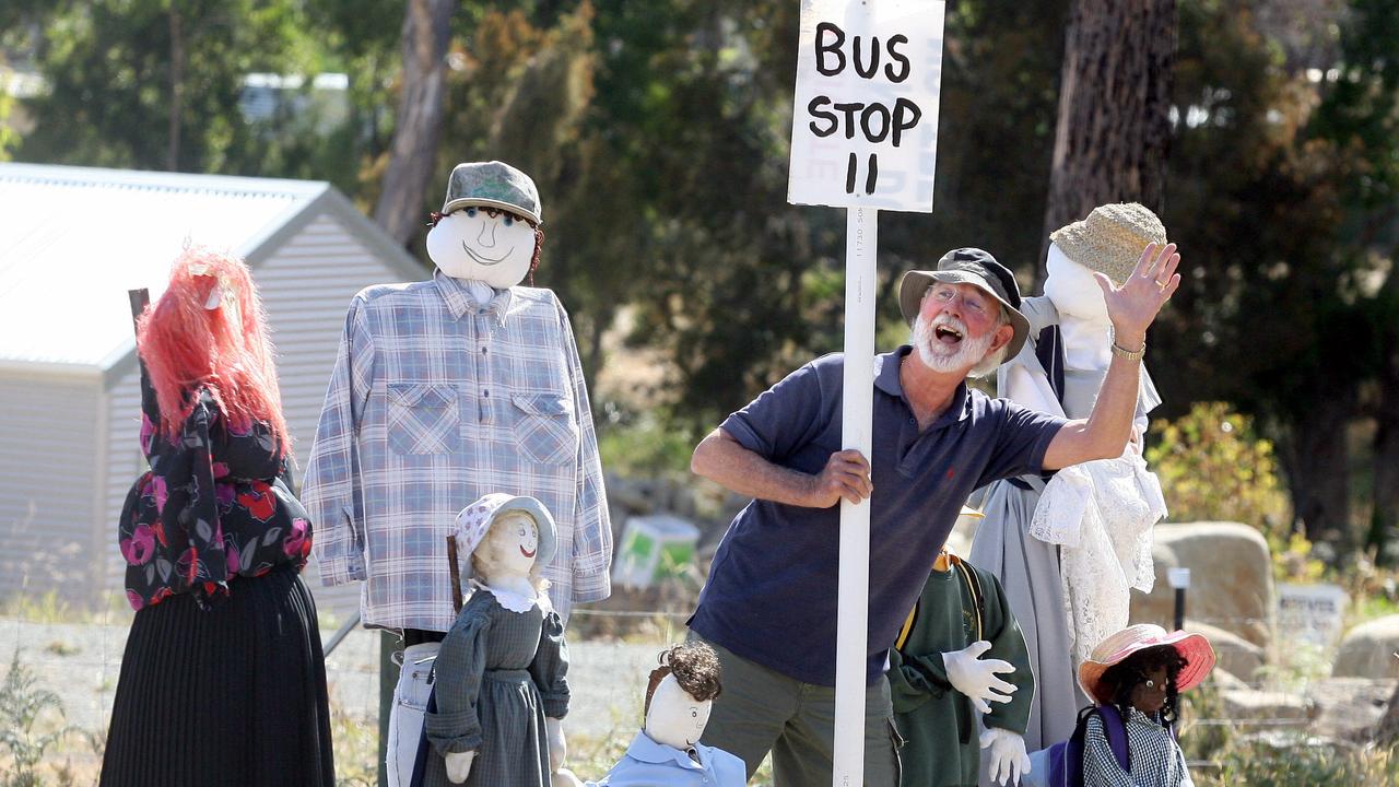 Middleton Country Fair scarecrow competition, one of the judges David McCarthy of Middleton, hams it up with a scarecrow family waiting for a bus at Verona Sands