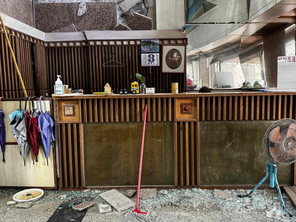 Debris is seen scattered around the lobby of an apartment building, damaged in the earthquake. Picture: AFP