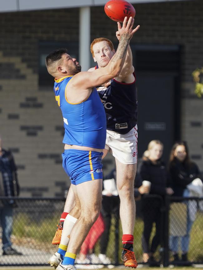 SFNL: Cranbourne’s Marc Holt is spoiled by John Walker of Springvale Districts. Picture: Valeriu Campan