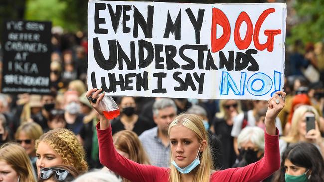 A woman holds up a placard during a protest against sexual violence and gender inequality in Melbourne today. Picture: AFP