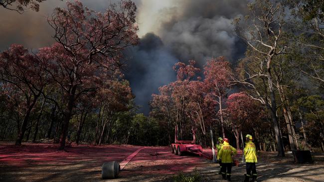 A Rural Fire Service crew prepare to defend a property at Gospers Mountain. Picture: AAP