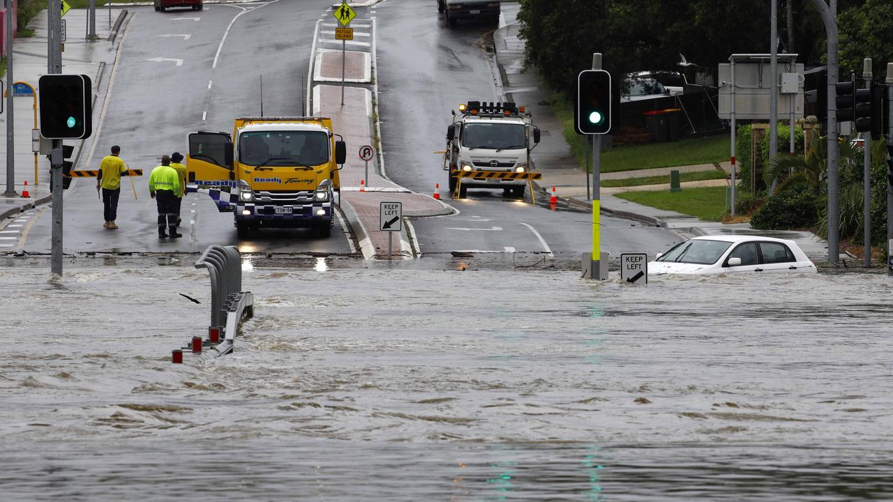 A car is stuck in flood waters in Toombul after heavy rain fell overnight in Brisbane. Picture: Tertius Pickard