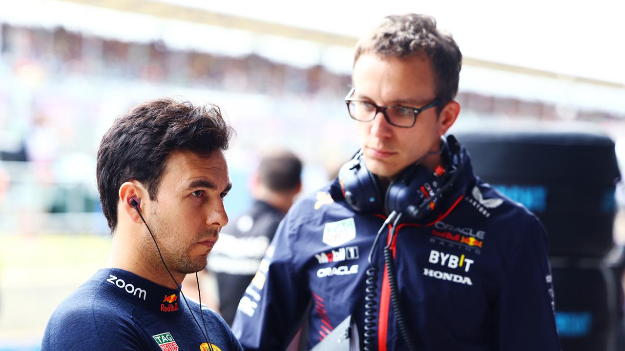 NORTHAMPTON, ENGLAND - JULY 08: Sergio Perez of Mexico and Oracle Red Bull Racing talks with race engineer Hugh Bird in the garage during qualifying ahead of the F1 Grand Prix of Great Britain at Silverstone Circuit on July 08, 2023 in Northampton, England. (Photo by Mark Thompson/Getty Images)