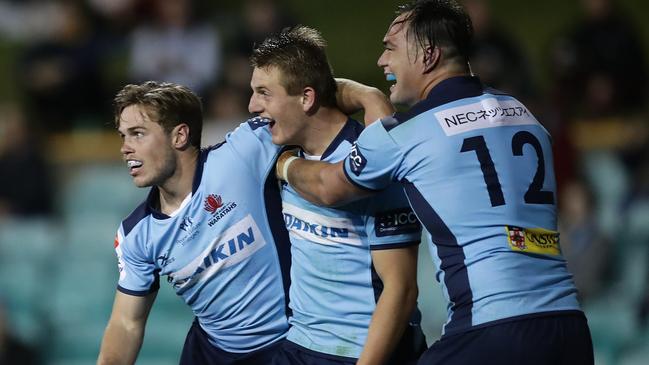 Joey Walton of the Waratahs celebrates scoring a try with teammates Tepai Moeroa and Will Harrison in 2020. Picture: Getty Images