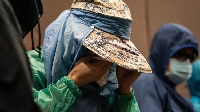 A family member of a Hong Kong resident detained by Chinese authorities wipes away tears during a news conference on Saturday in Hong Kong. Picture: Getty Images