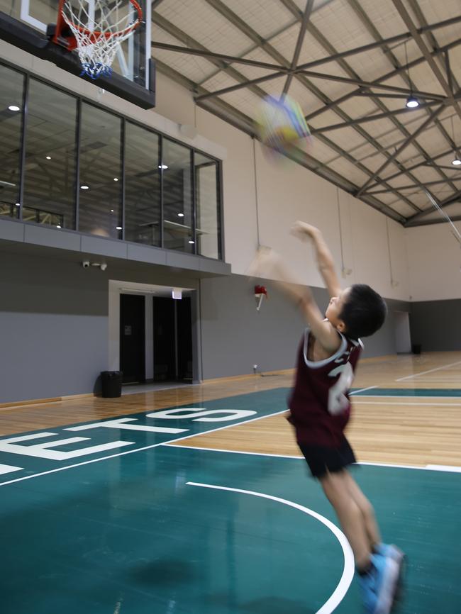 Osbon Liu takes the first shot on the new courts at Hills Sports Stadium.