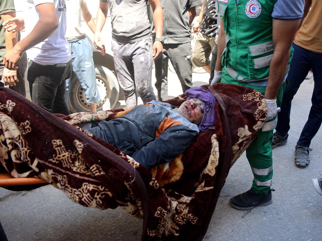 Palestinians carry a stretcher with an injured child after the Israeli military bombardment of Gaza City. Picture: Omar Al-Qattaa/AFP