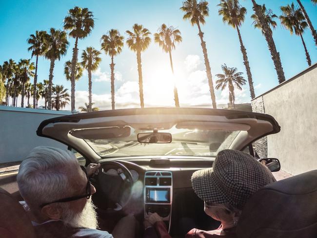 Senior trendy couple inside a convertible car - Mature people having fun doing a road trip in a tropical place - Travel, fashio and joyful elderly concept - Main focus on woman hatEscape 5 Novemeber 2023Doc Holiday Photo - iStock