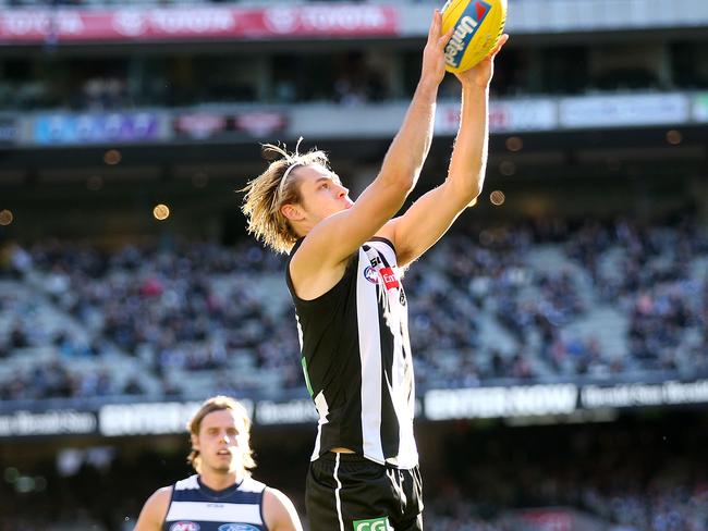 Darcy Moore was injured in the second term against the Cats. Pic: Michael Klein